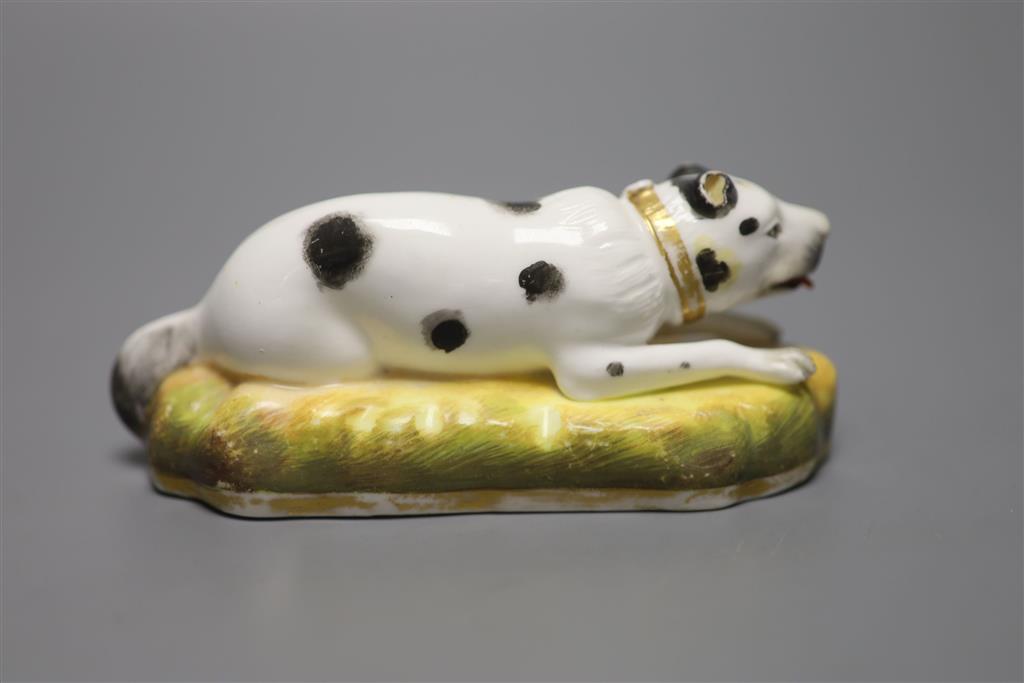 An English porcelain figure of resting dog, c.1830-50, width 13cm